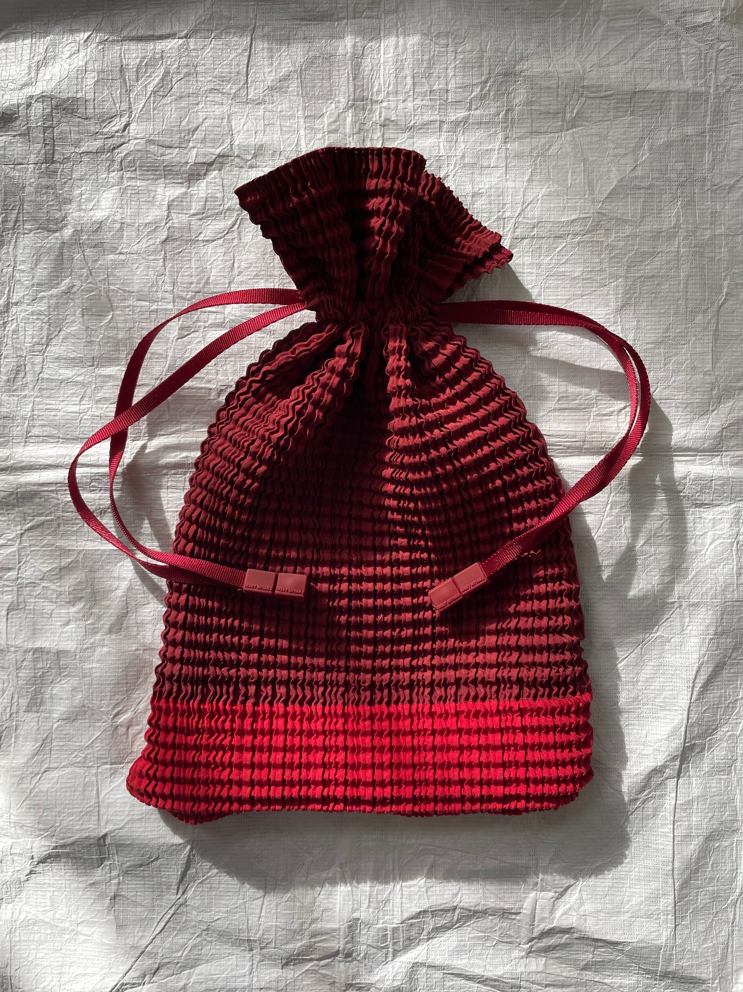 Issey Miyake red drawstring bag