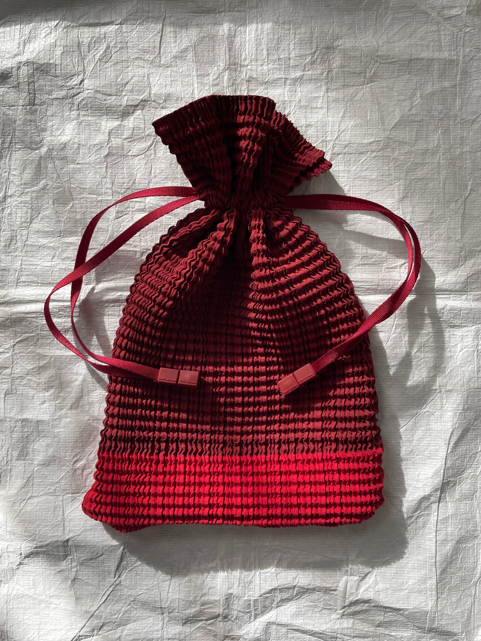 Issey Miyake red drawstring bag