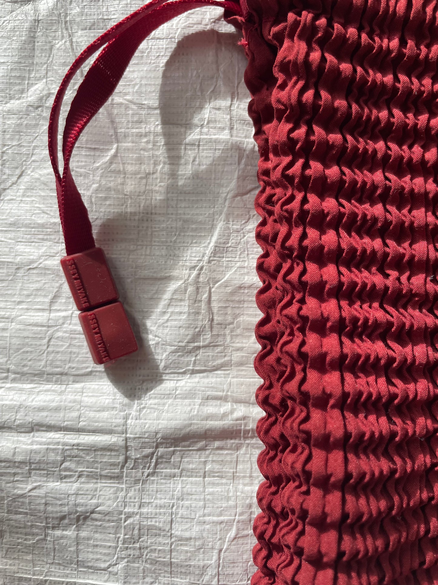 Issey Miyake red drawstring bag