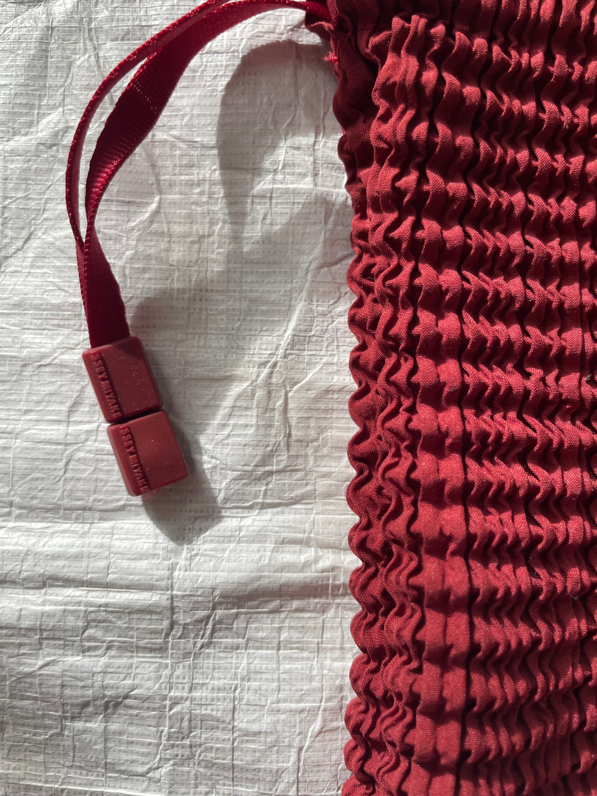 Issey Miyake red drawstring bag