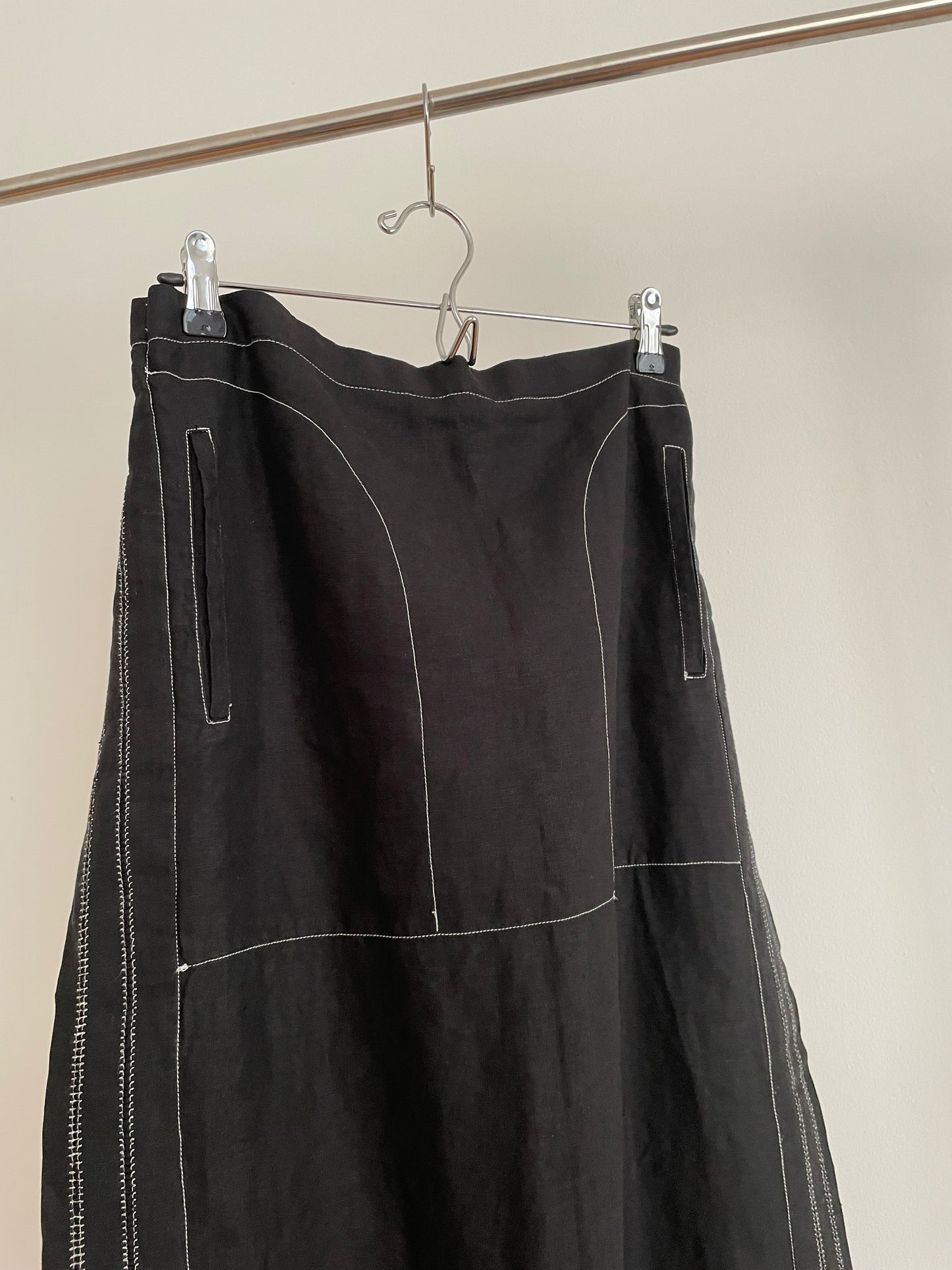 Detail view of womens vintage Issey Miyake black skirt with white contrast stitch