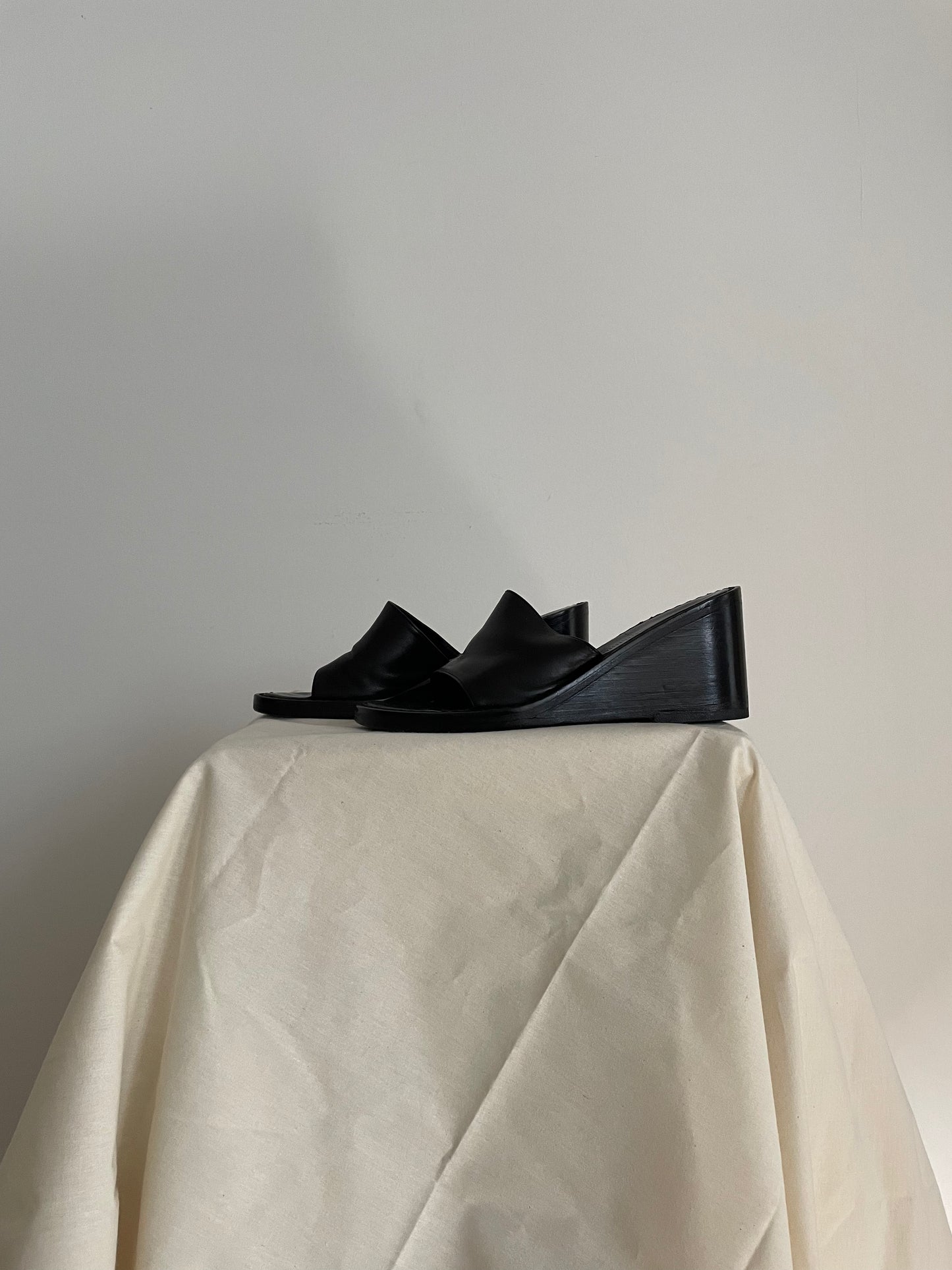Side view of womens black Ann Demeulemeester wedge sandals