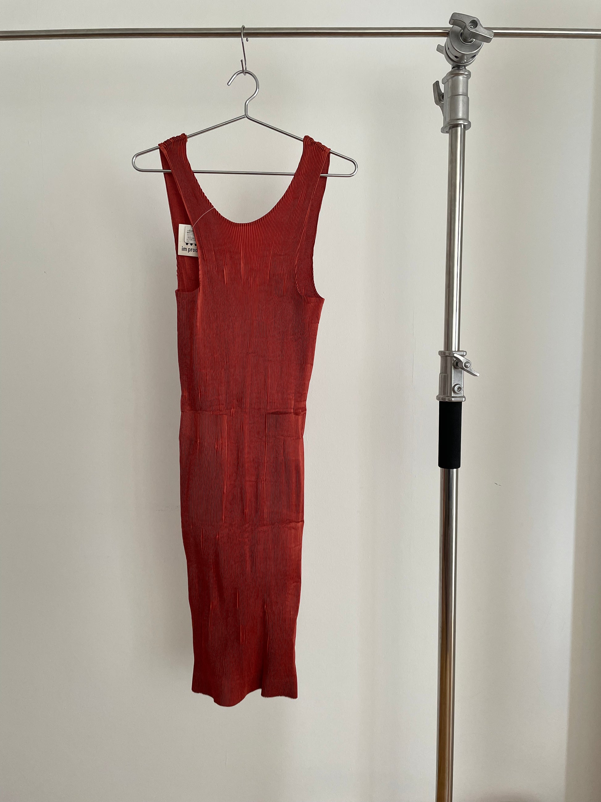 Front view of vintage IM Product red pleated apron dress