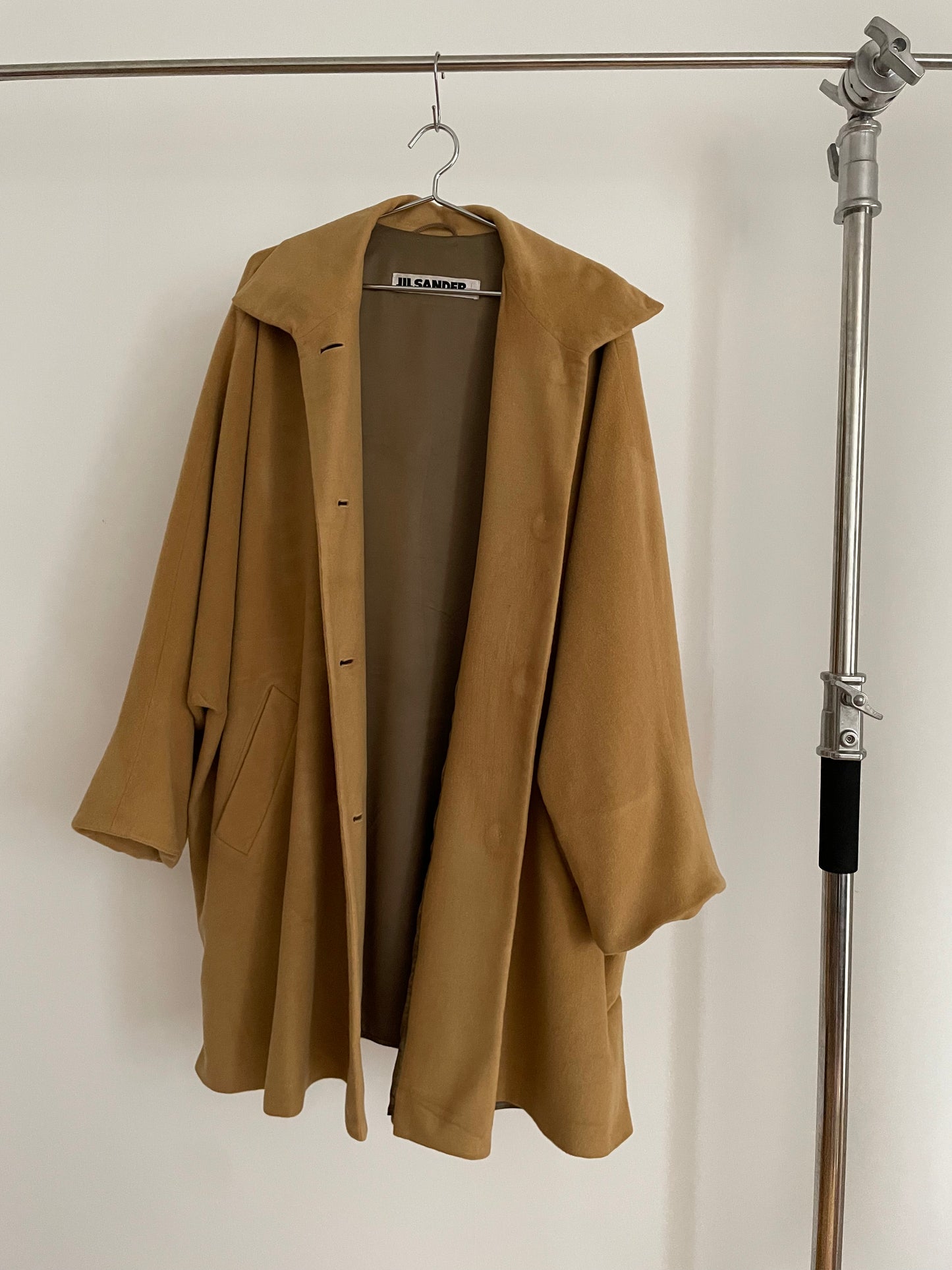 Front view of vintage womens Jil Sander 1980s camel dolman sleeve coat