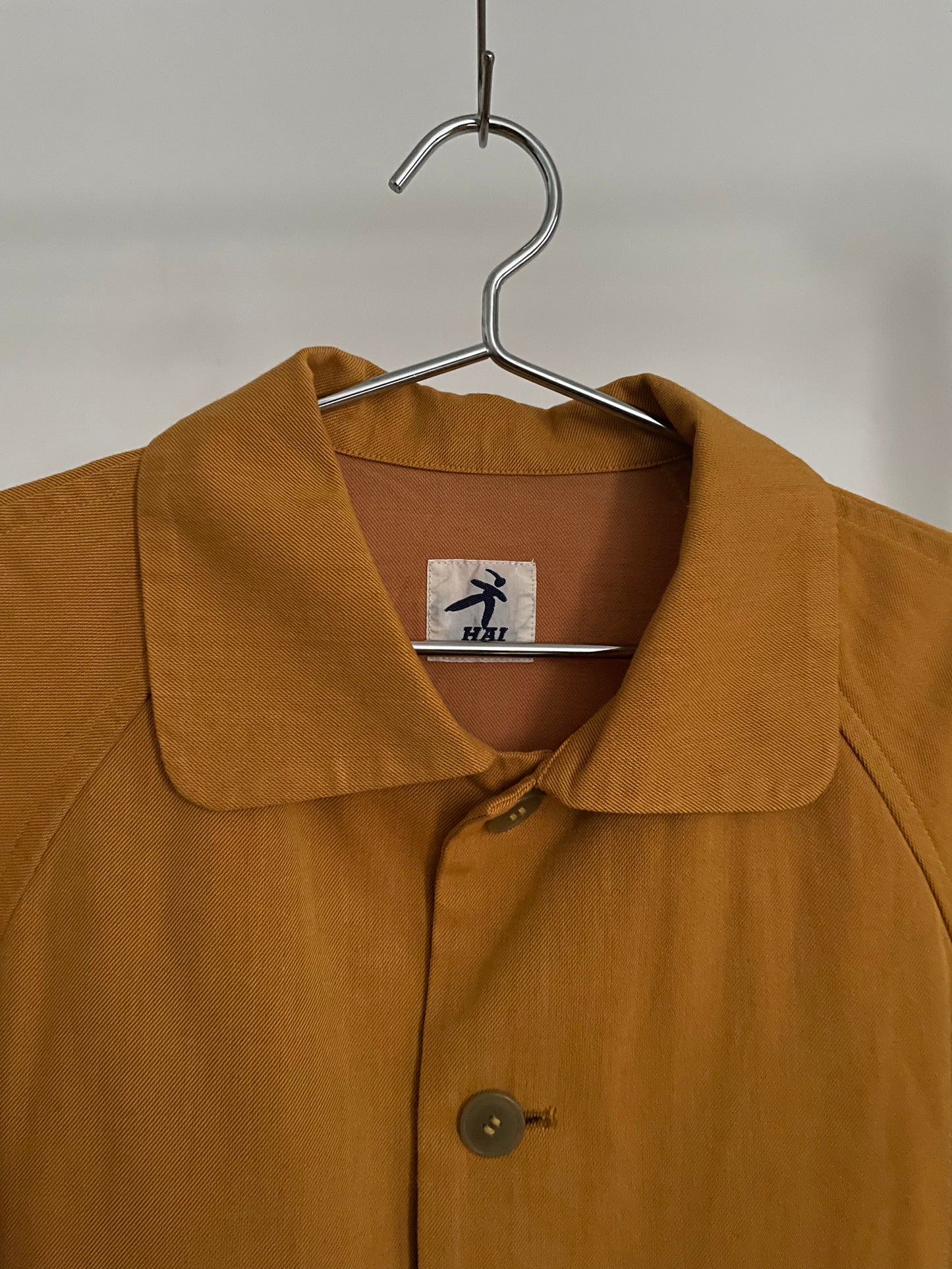 Detail view of vintage womens HAI Sporting Gear mustard yellow chore coat