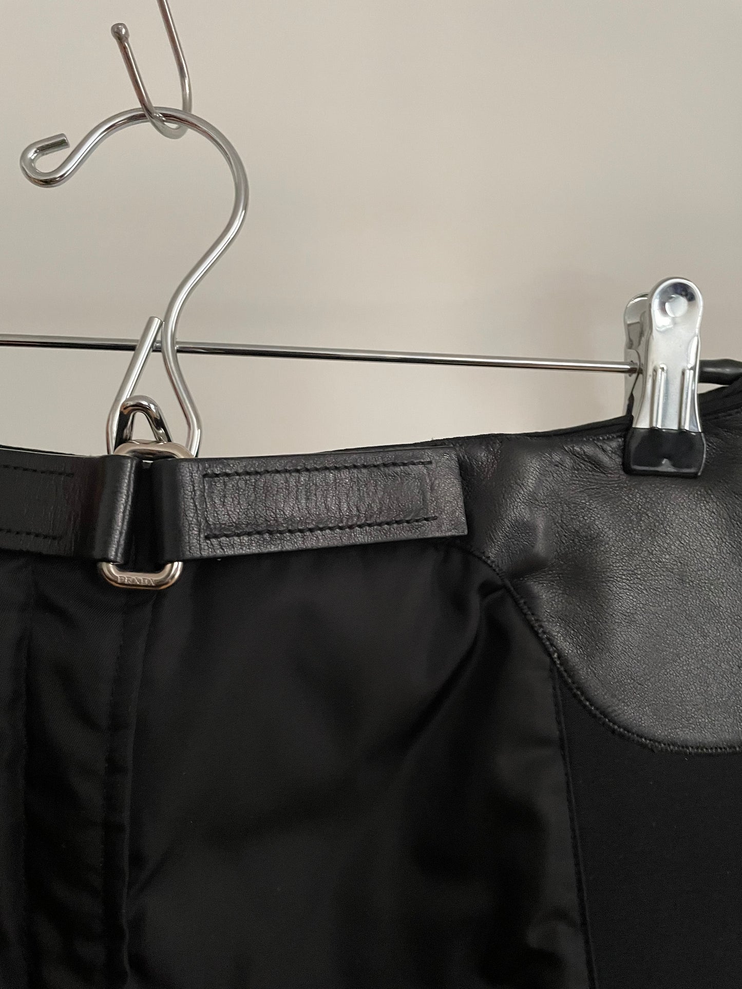 Detail view of vintage womens black Prada skirt in nylon and neoprene with leather details