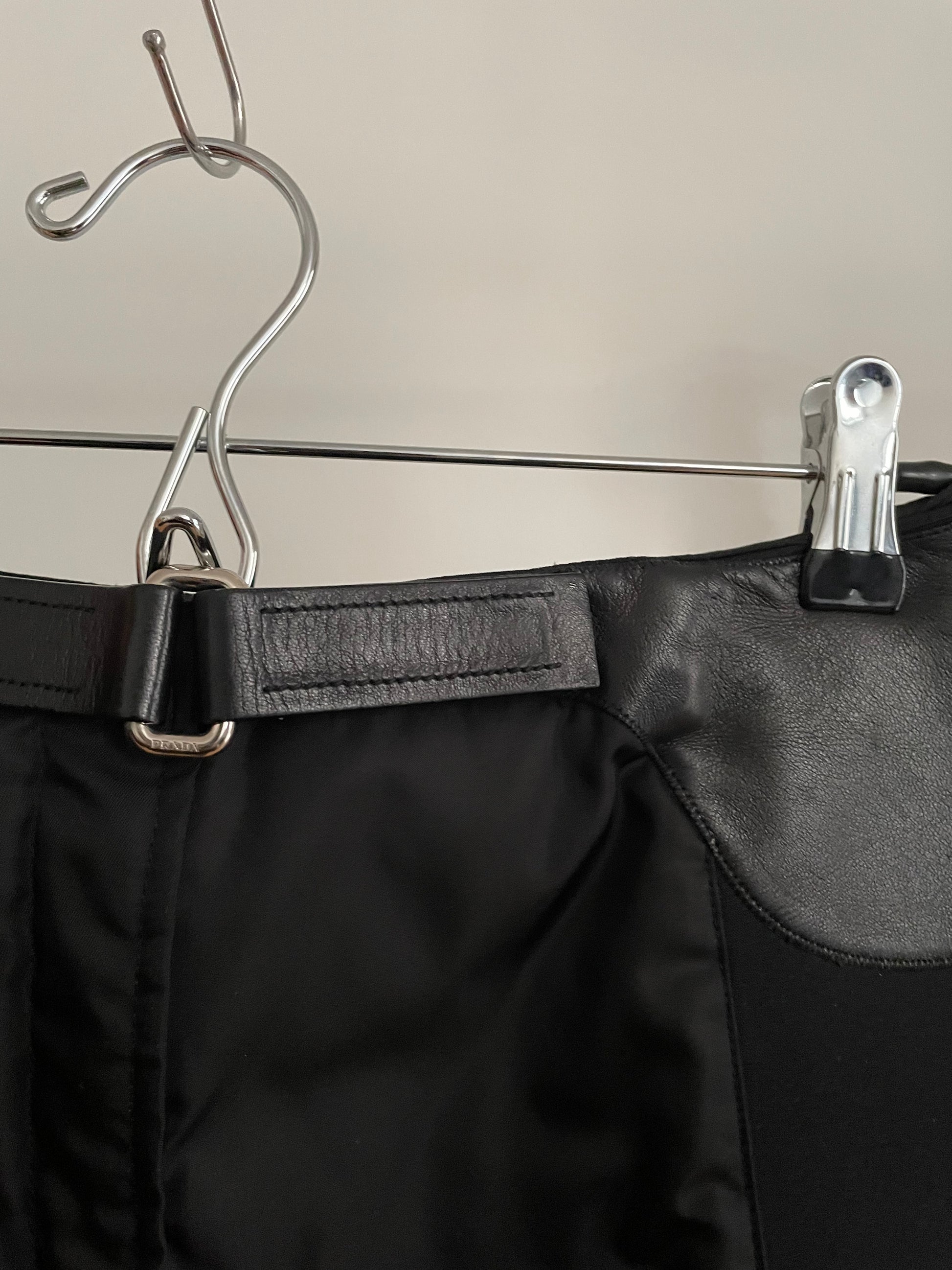 Detail view of vintage womens black Prada skirt in nylon and neoprene with leather details