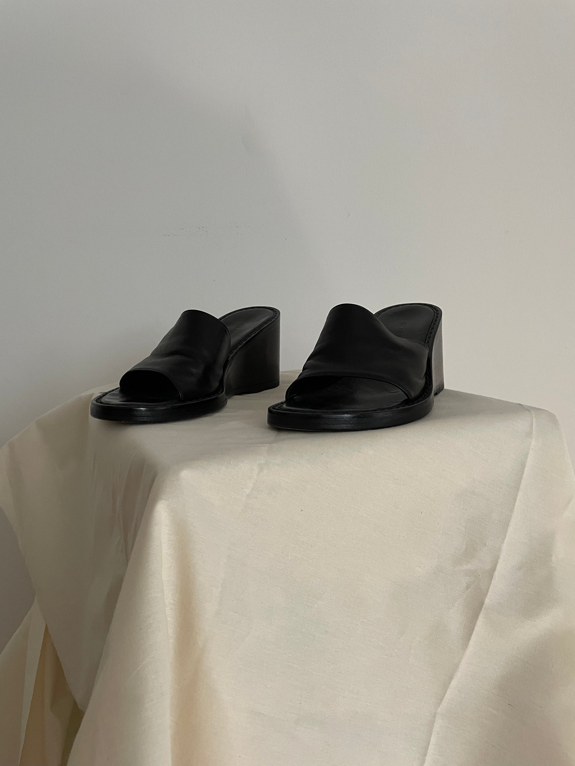 Front view of womens black Ann Demeulemeester wedge sandals
