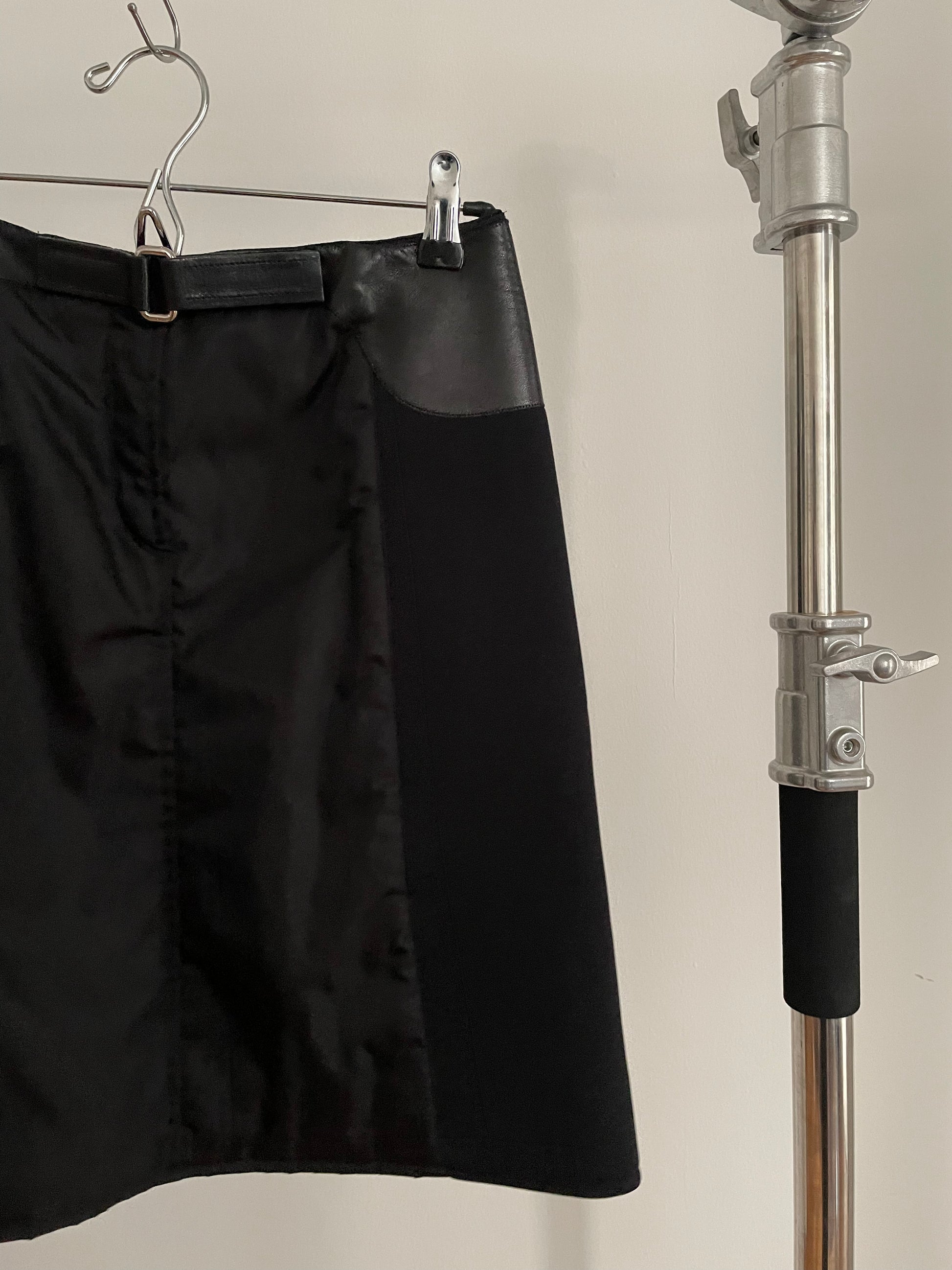 Detail view of vintage womens black Prada skirt in nylon and neoprene with leather details